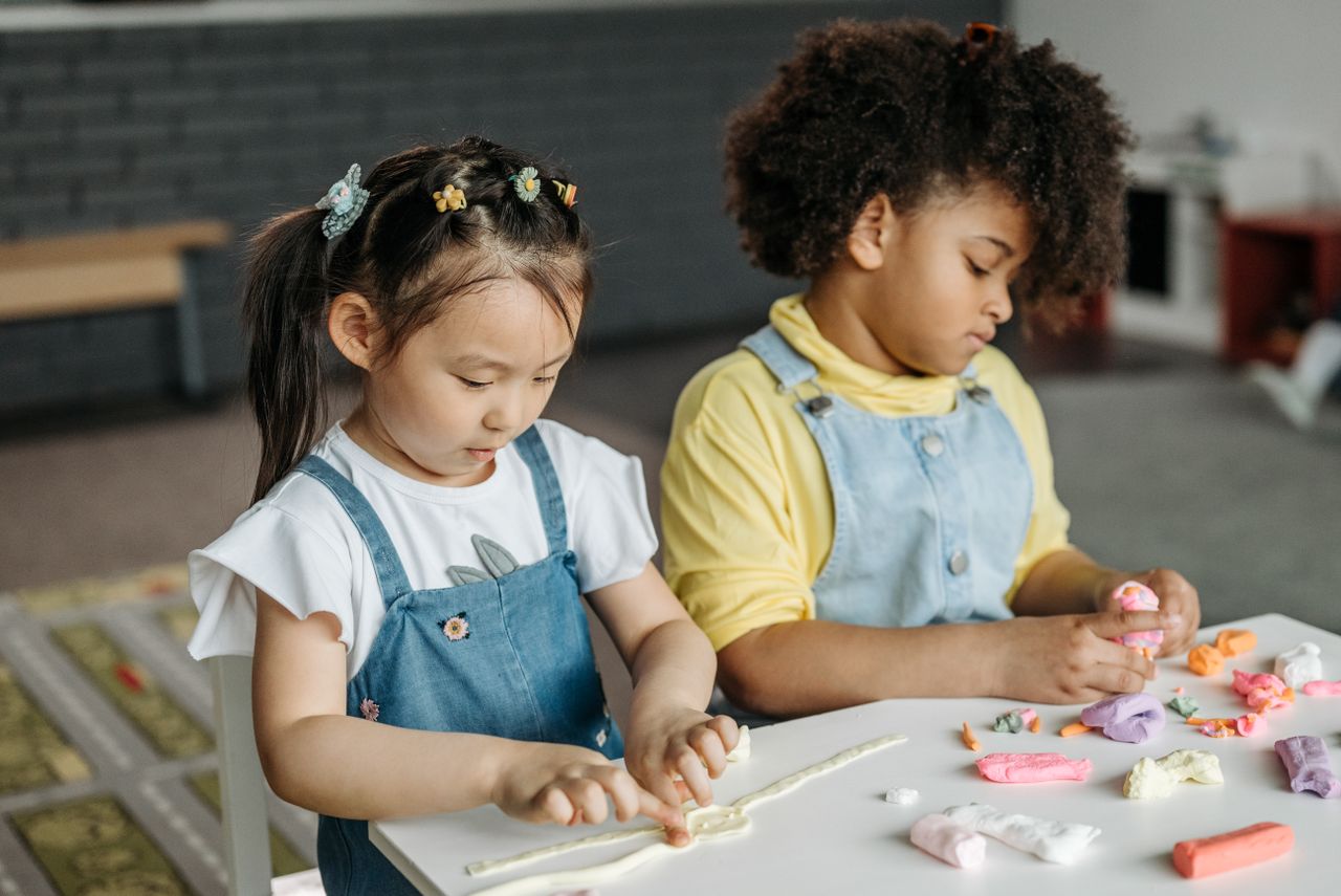 Children exploring creative arts through clay and hands-on expression