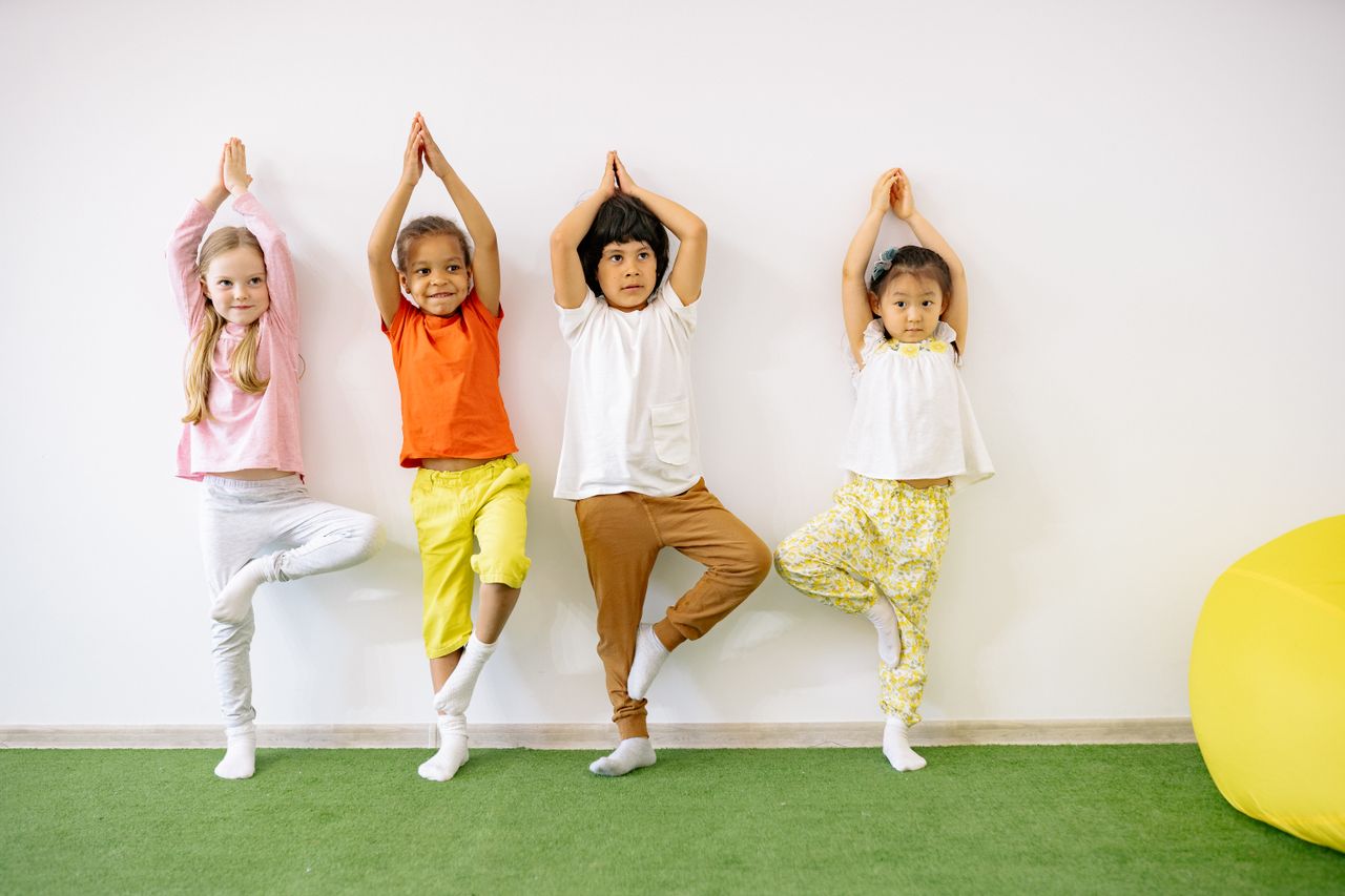 Children practicing balance and movement activities together