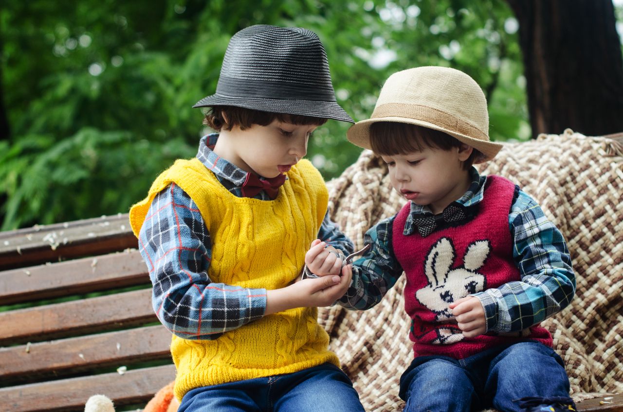 An older Montessori child supporting a younger classmate with patience and care