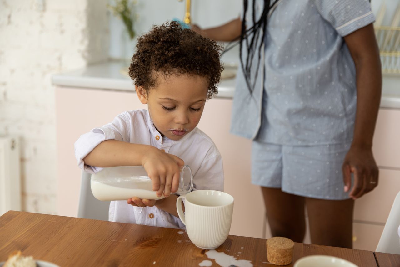A young child developing independence through a Montessori pouring activity