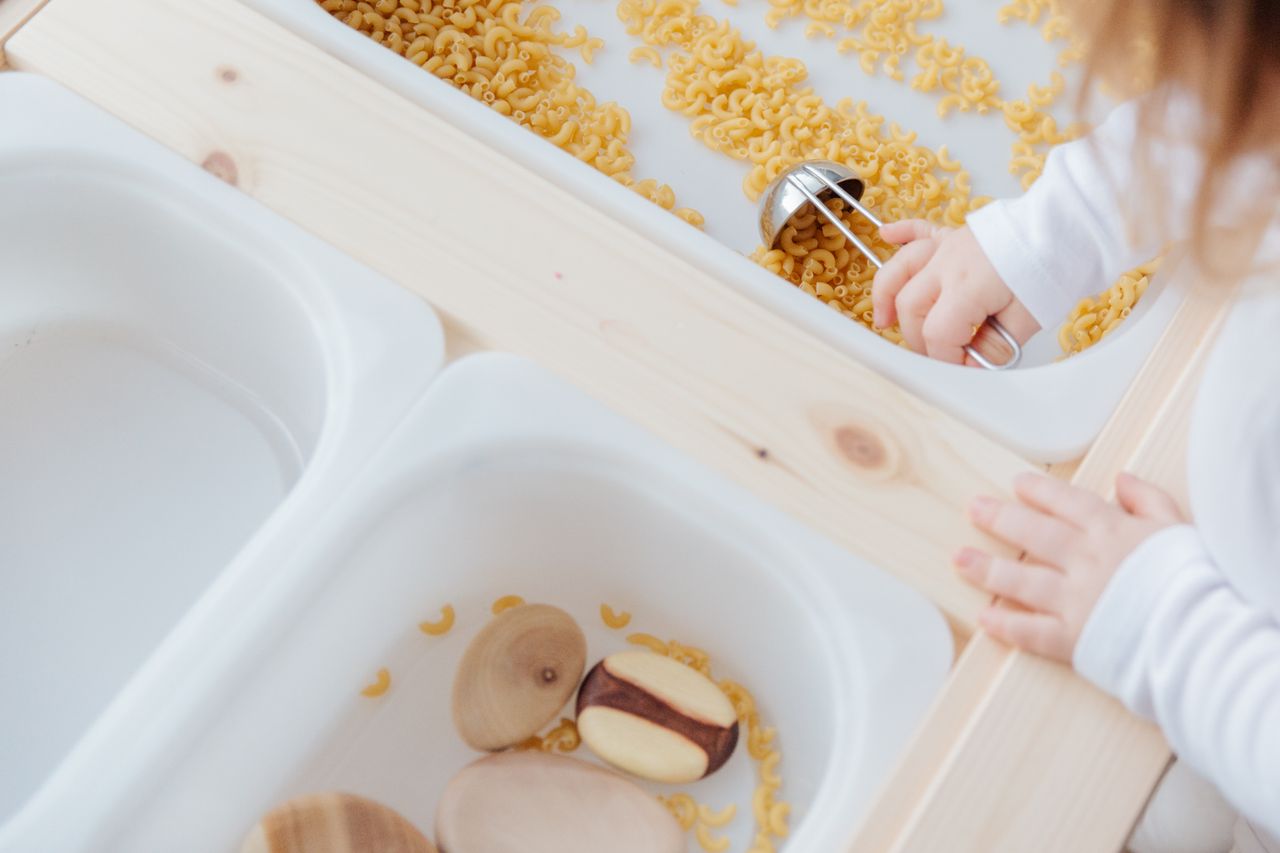 A child developing sensory awareness through a hands-on Montessori exploration activity