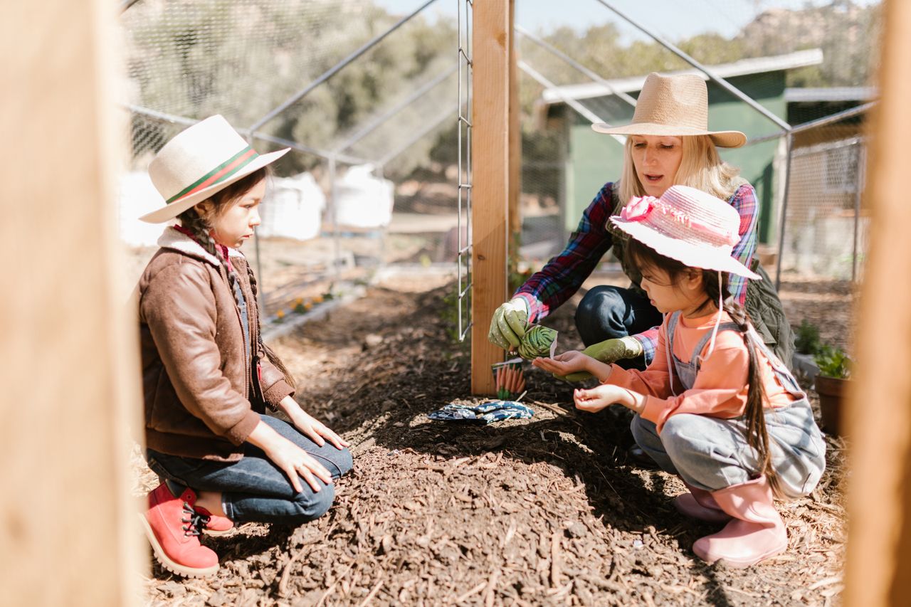 Children exploring and gardening outdoors in a natural learning environment