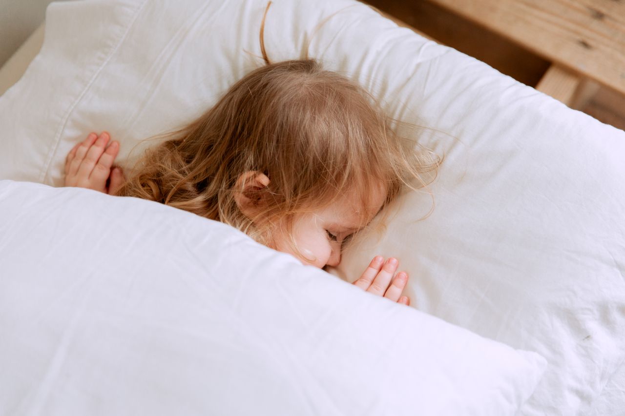 A young child resting peacefully in a calm and comfortable environment