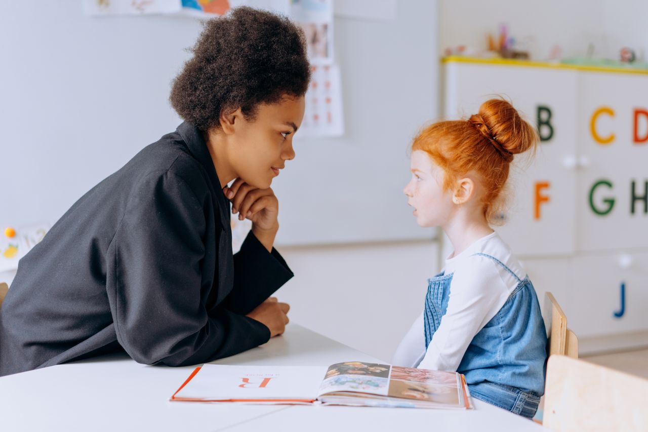 An educator offering respectful individual guidance to a young child