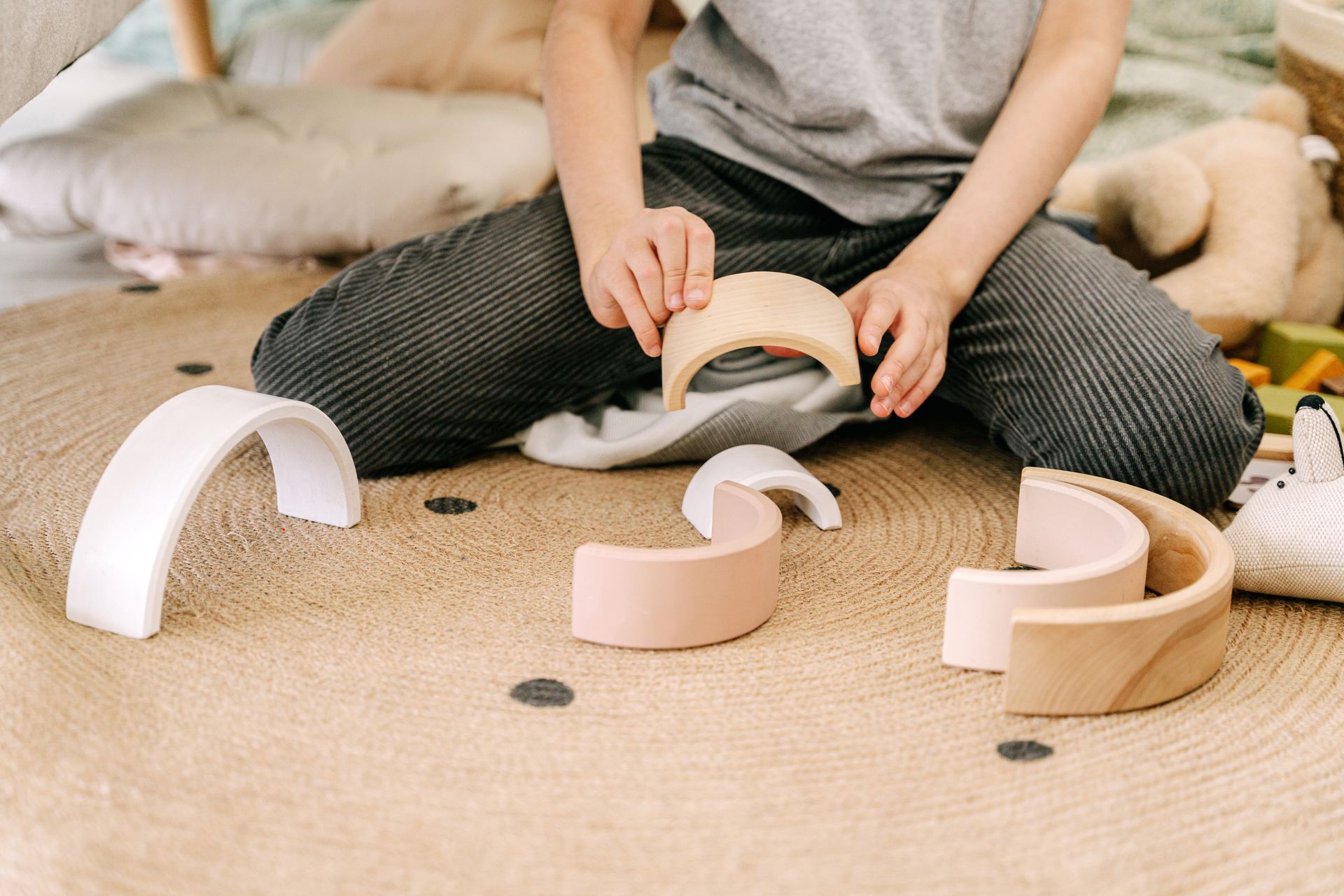 Child concentrating on a hands-on wooden learning activity