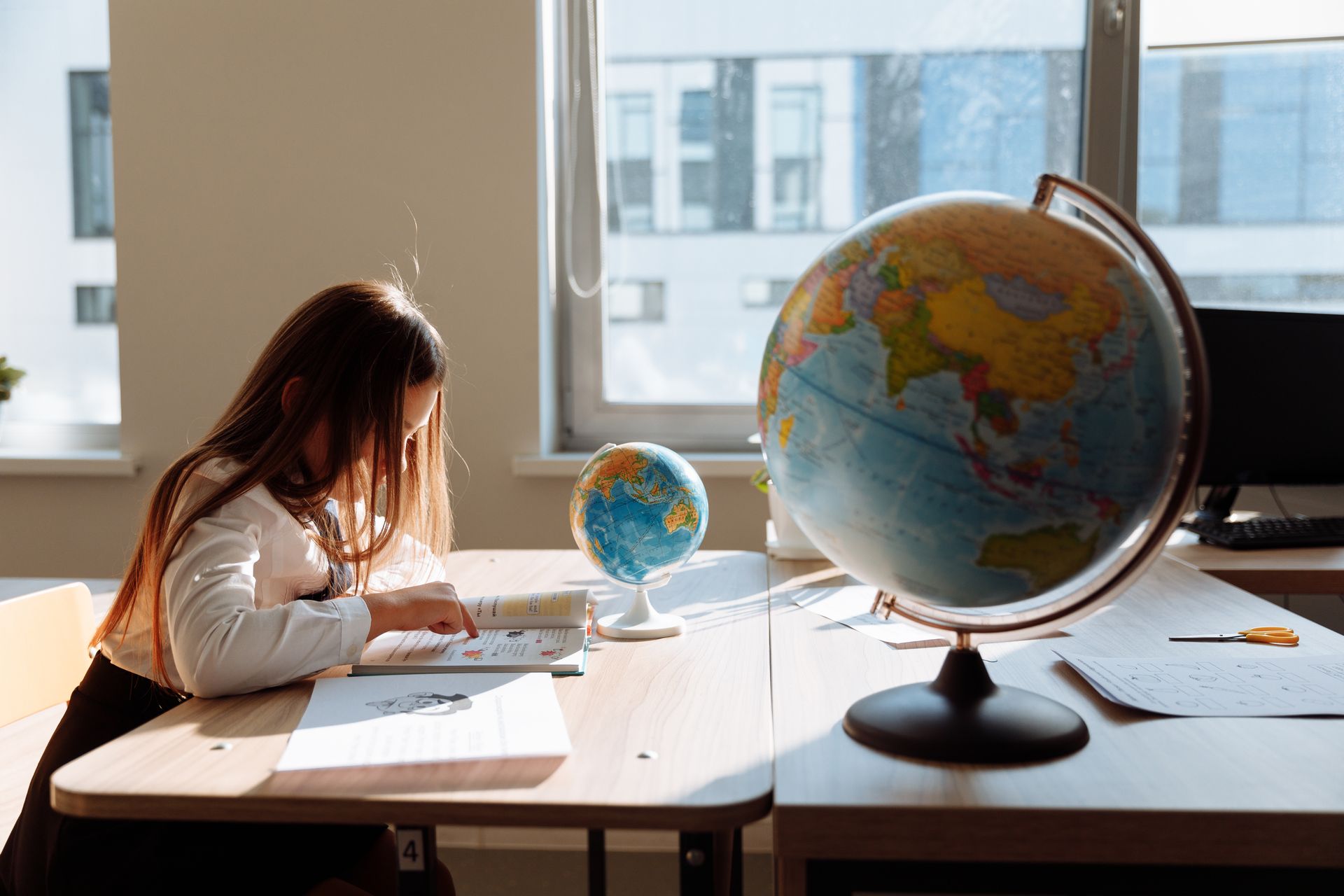 Child exploring geography through hands-on classroom learning